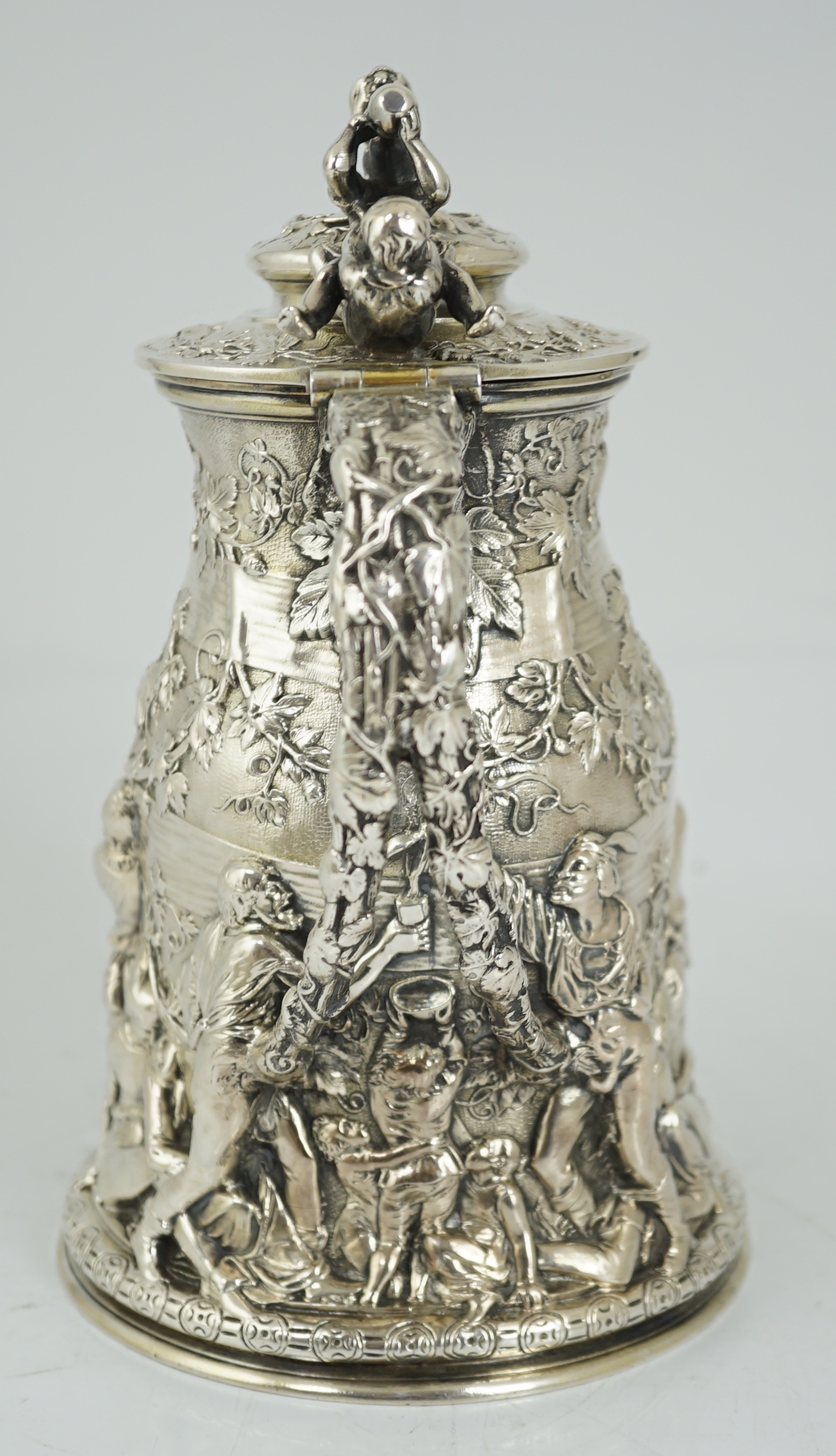 ROYAL INTEREST: A good ornate Victorian Teniers style silver ewer with hinged cover by Frederick Elkington